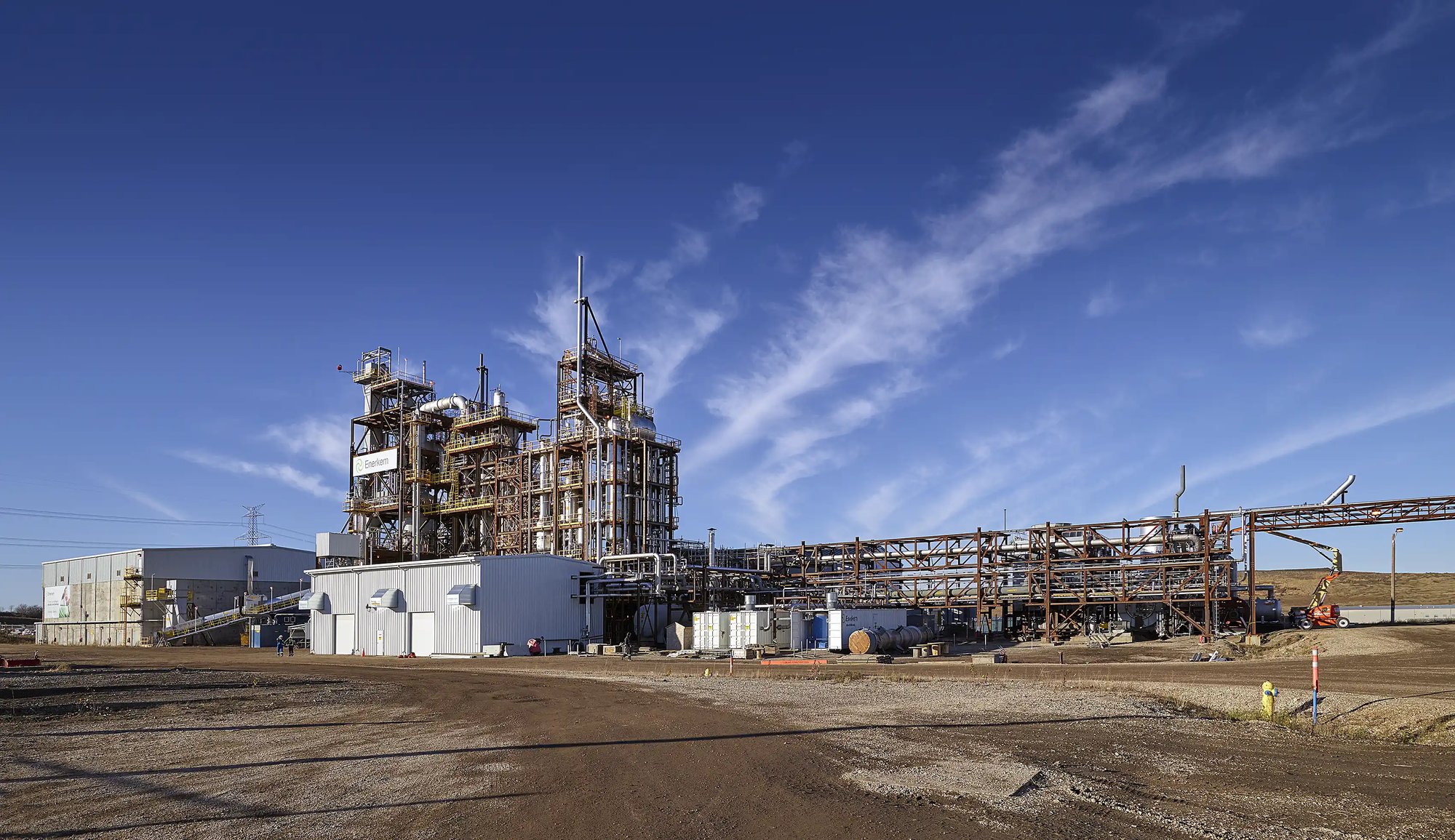 a large industrial building with a blue sky