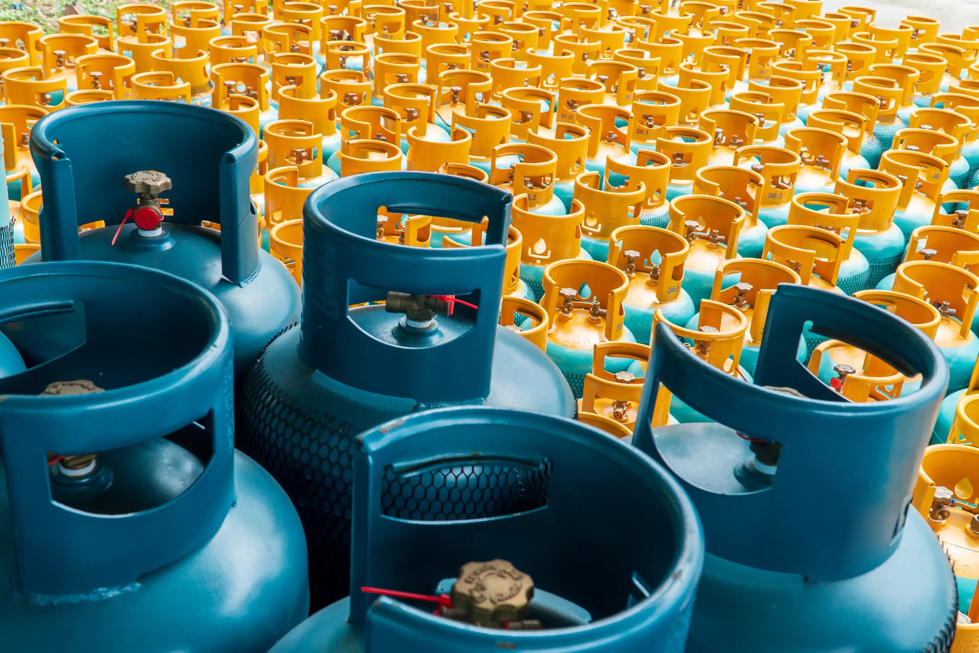 a group of blue and yellow gas cylinders